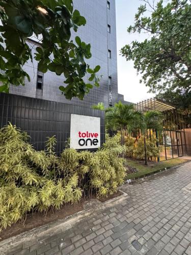 a sign for a leave one sign on a building at Tolive One - Leite Island, Recife in Recife