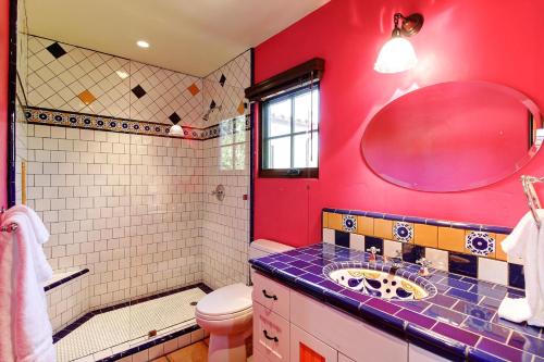 a red bathroom with a sink and a toilet at West Beach Villa 5 & 6 in Santa Barbara