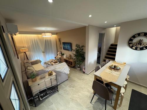 a living room with a couch and a table at The 50 50 Deluxe Apartments in Sidari