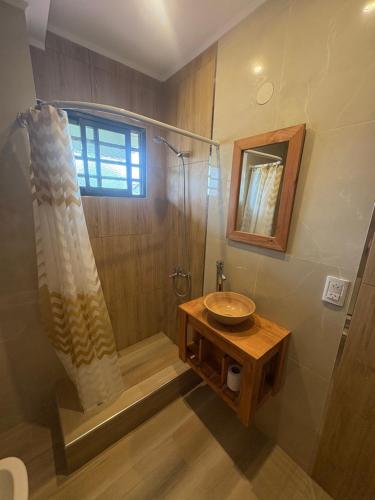 y baño con ducha, lavabo y lavamanos. en Rincon del Oceano, en Santa Teresita