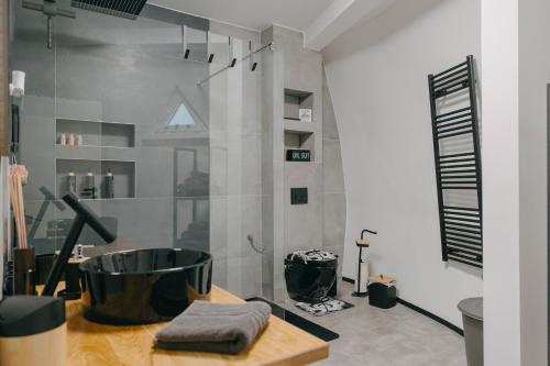 a bathroom with a tub on a wooden table at Dome Noire in Puškarič Selo