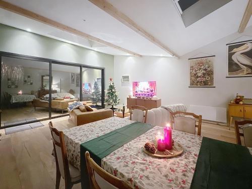 a living room with a table with a candle on it at Maison à 2 min de la plage Saint Georges de Didonne in Saint-Georges-de-Didonne