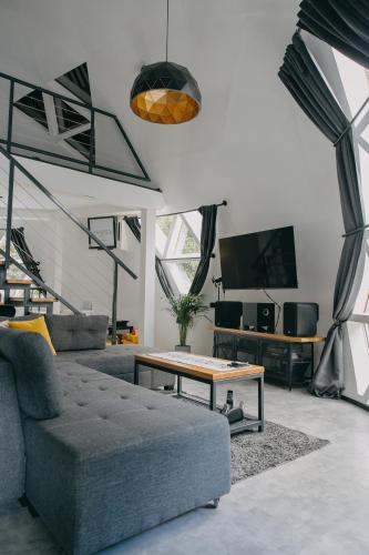a living room with a couch and a coffee table at Dome Noire in Puškarič Selo