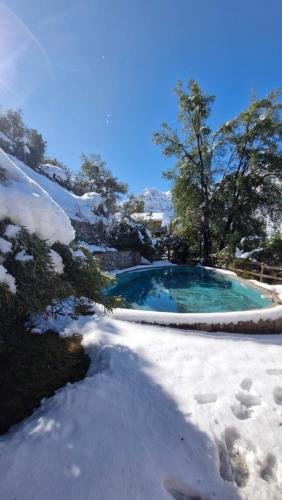 a swimming pool with snow on the ground at Luna del maipo in El Ingenio