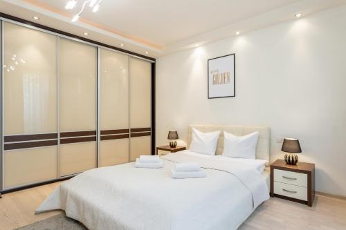 - une chambre blanche avec un grand lit et des draps blancs dans l'établissement Urban Chic - One Bedroom Apartment -Luxury Warsaw Stays - Grzybowska 5, à Varsovie