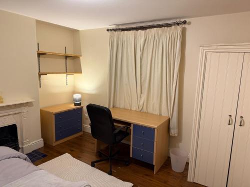 a bedroom with a desk and a bed and a window at Collin street in Nottingham
