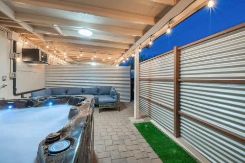 a large bathroom with a tub and a couch at 3BR 2BA Comfy Home with Jacuzzi in Tucson