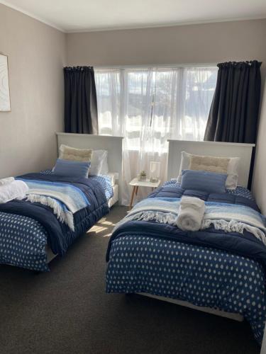 a bedroom with two beds and a window at City Central in Nelson