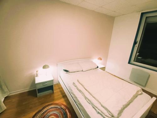 a small bedroom with a bed and a window at L'échappée Belle face aux Falaises in Le Tréport