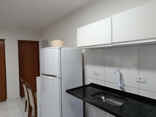 eine Küche mit Kühlschrank und Arbeitsplatte in der Unterkunft Apê econômico a 4 km de Muro Alto in Ipojuca