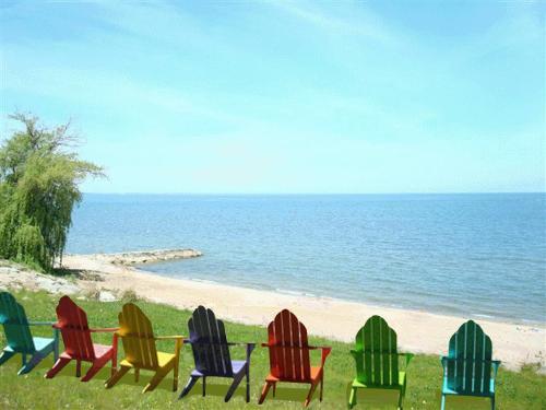 a group of chairs sitting on the beach at Firefly Beach in Huron