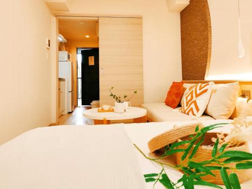 a living room with a bed and a couch at Minami Ikebukuro APT Dear Cosmo Ikebukuro subway 6mins in Tokyo
