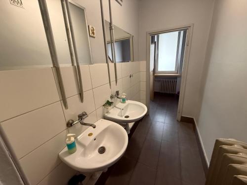 a bathroom with two sinks and a mirror at Noclegi Maria in Chełm