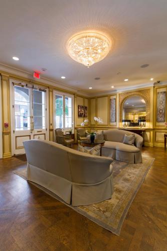 a large living room with couches and a chandelier at Hotel Mazarin in New Orleans