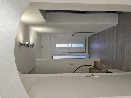 a white kitchen with a sink and a window at Charmantes Haus mit eigenem Garten in Prien am Chiemsee