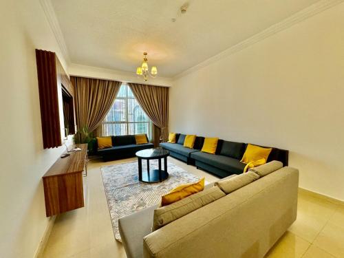 a living room with a couch and a table at Deira Luxurious unit in Dubai
