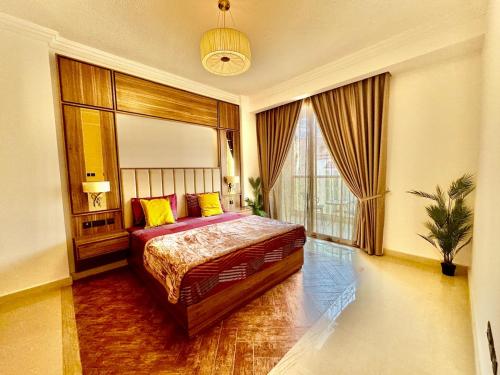 a bedroom with a bed and a large window at Deira Luxurious unit in Dubai