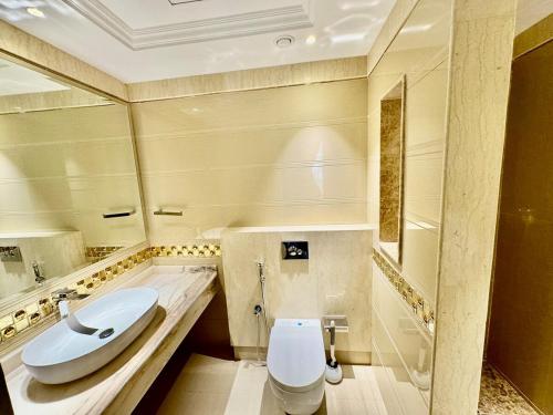 a bathroom with a toilet and a sink at Deira Luxurious unit in Dubai