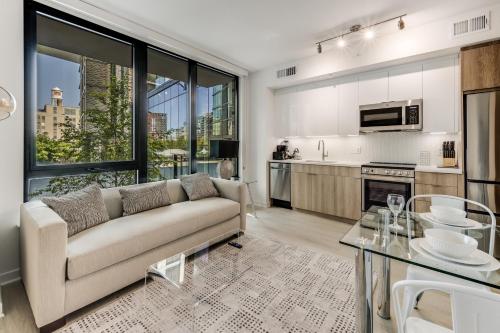 a living room with a couch and a kitchen at Bluebird Suites at Capitol Hill in Washington, D.C.