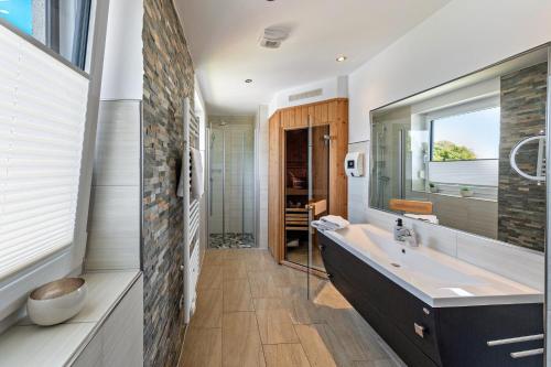 a bathroom with a large tub and a sink at Casa Fortuna in Göhren-Lebbin