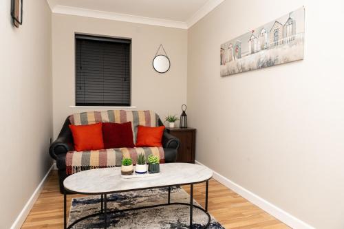 a living room with a couch and a table at RB home Stockport in Stockport