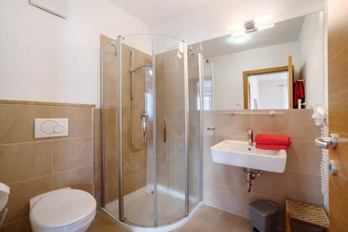 um banheiro com chuveiro, vaso sanitário e pia em Fröhlichhof Wohnung Pergola em Lagundo