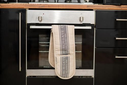 a towel is hanging from an oven door at RB home Stockport in Stockport