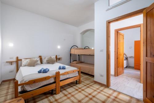 a bedroom with a bed and a bunk bed at Villa Gaudì - Pedrera in Sant'Isidoro