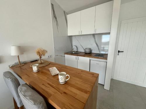 a kitchen with a wooden table with two cups on it at Monte Paraíso Beach in Puerto Rico de Gran Canaria