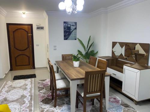 a dining room with a wooden table and chairs at Wide Seaview 3-Bedroom Apartment in Alexandria