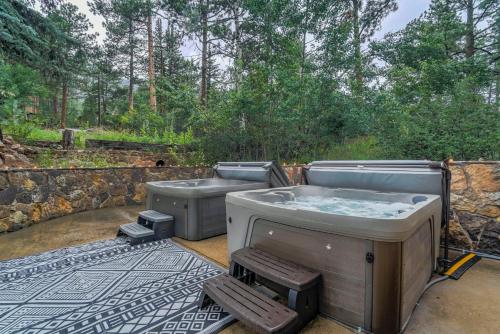 two hot tubs on a patio next to a stone wall at 4925 Pike in Cascade-Chipita Park