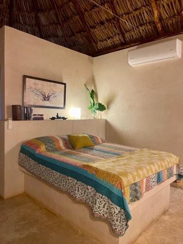 a bedroom with a bed in a room at Cabañas HUNAB KU 21 in Hocabá