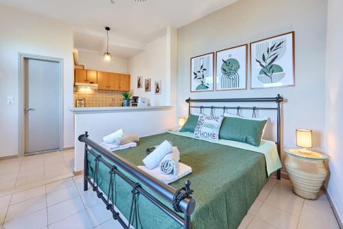 a bedroom with a bed with a green bedspread at Dolphin studio in Gaios