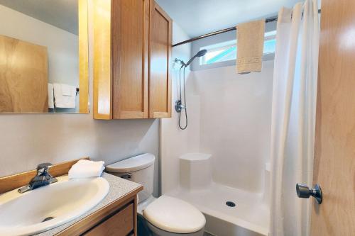 a bathroom with a sink and a toilet and a shower at Oceanfront Views! Hot Tub! Starlit Shores in Yachats