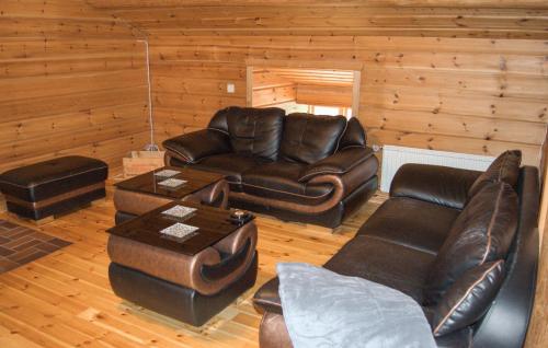 a living room with a leather couch and a table at Lovely Home In Kopparberg With Sauna in Kopparberg