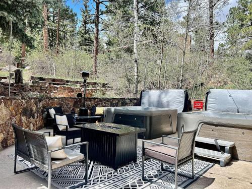 a patio with a grill and chairs and a table at 4925 Pike Unit1 in Cascade-Chipita Park