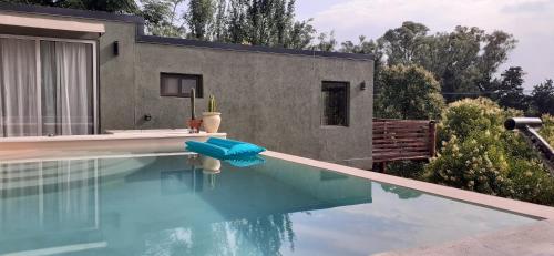 a swimming pool in front of a house at Vista Alago in Villa Ciudad Parque