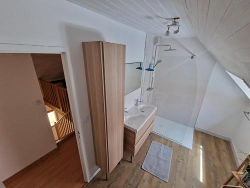 an attic bathroom with a sink and a shower at Belle maison vue mer 5min de plage in Plouarzel