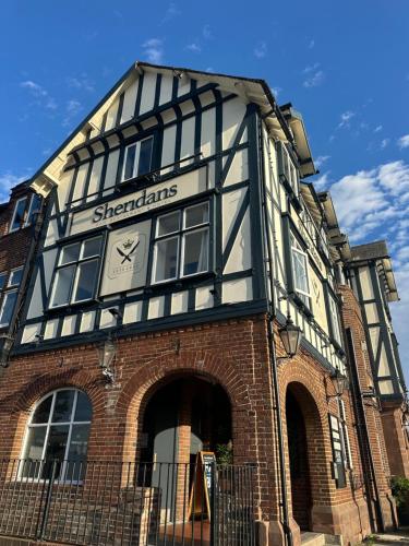 a black and white building with a clock on it at Sheridans hotel in Wallasey