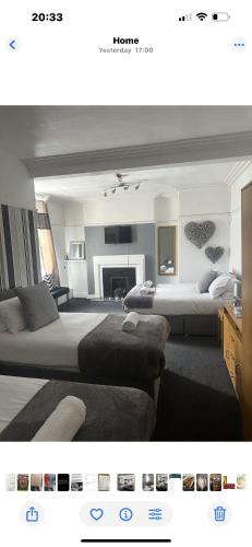 a bedroom with two beds and a living room at Sheridans hotel in Wallasey