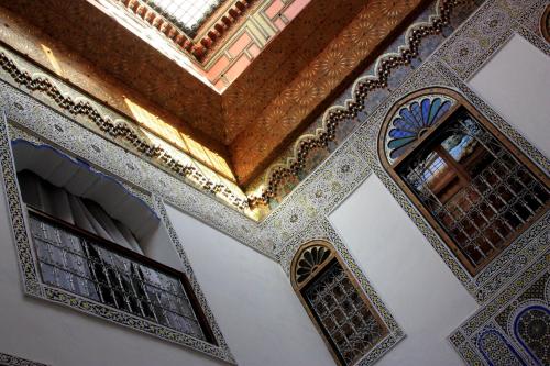 an ornate ceiling and windows in a mosque at Dar El Bali in Fez