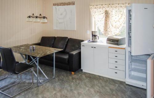 a living room with a black couch and a table at Pet Friendly Home In Kopparberg With Lake View in Kopparberg