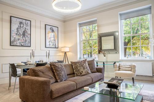 a living room with a couch and a table at 10 Park Square East, Luxury Serviced Apartments in Leeds