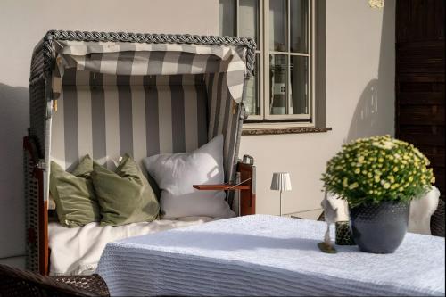 a bedroom with a canopy bed with a potted plant at Taun Hövt in Groß Zicker