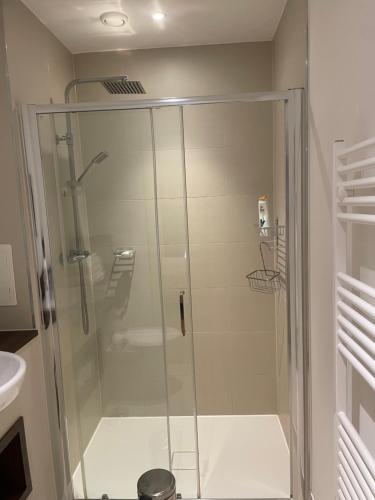 a shower with a glass door in a bathroom at Near Wembley Stadium ,london Uk BOOk now in London