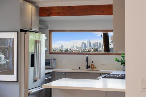 a kitchen with a view of a city skyline at Hillside House with DTLA Views in Los Angeles