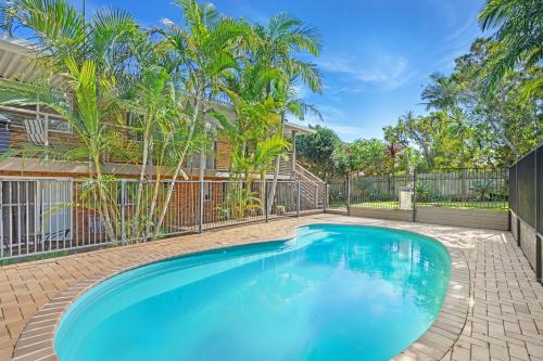 a swimming pool in the backyard of a house with trees at Beachside Bliss Spacious Forster Getaway in Forster