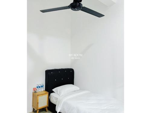 a bedroom with a bed and a ceiling fan at My Room Sri Aman in Kampong Lamanak