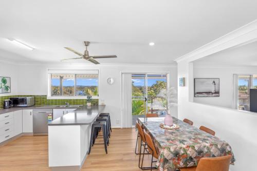 a kitchen and dining room with a table and chairs at Beachside Bliss Spacious Forster Getaway in Forster