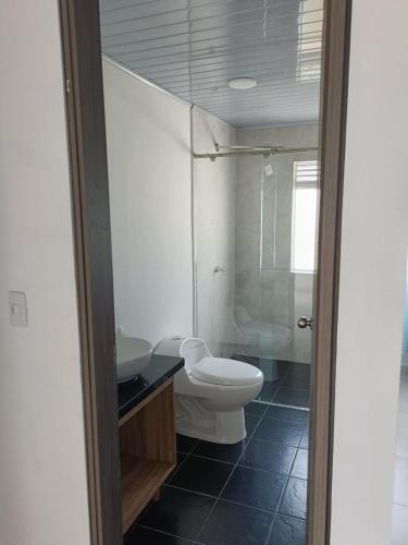 a bathroom with a toilet and a sink and a shower at La Mesa Suites - Hermosa vista in La Mesa